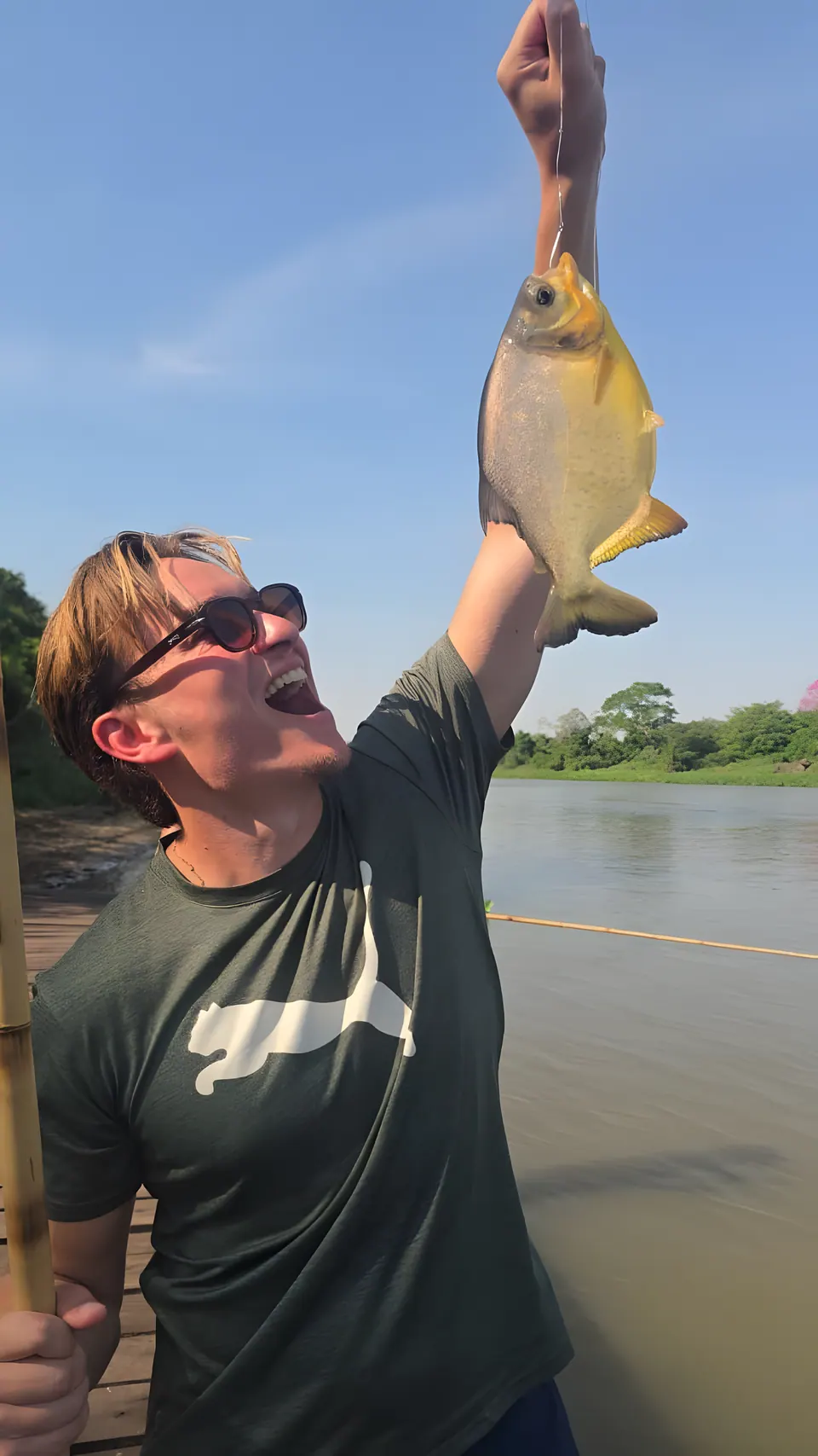 Ein Gast hält einen Piranha hoch